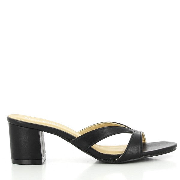 The photo features a pair of Dalessi Daily Black Slide Heels, showcasing their sleek black synthetic upper. The round toe shape offers a comfortable, stylish fit, while the soft leather lining ensures a luxurious feel. The 6 cm heel adds a subtle lift, perfect for both casual and dressier occasions. The synthetic sole provides durability and support, making these heels practical for everyday wear. The simple yet elegant design makes these heels a versatile addition to any wardrobe.