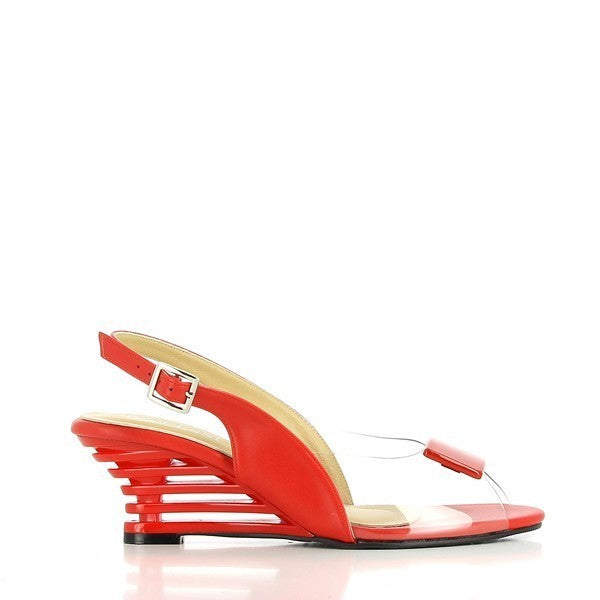 A pair of Dalessi Dali Red Slingback Heels showcased against a neutral background, emphasizing their bold and sophisticated design. The vibrant red synthetic upper is complemented by a transparent front panel, giving a modern and airy feel. The unique 6.5 cm decorative heel adds a stylish touch, while the rounded toe and soft leather lining ensure comfort. The slingback strap provides a secure fit, making these women’s shoes both fashionable and functional. 