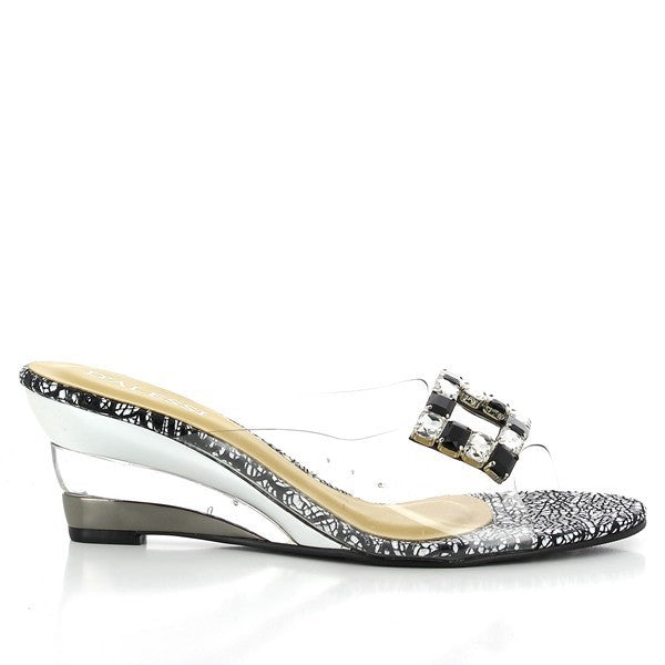 The Dalessi Damsel Black Slides from the side, showcasing the sleek synthetic black upper and the elegant 6 cm heel. The silver buckle adds a modern touch.