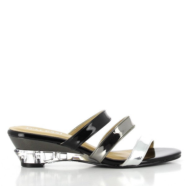 Side view of the Dalessi Deflect Black & Silver Slides, showing the three front straps in contrasting black, pewter, and silver tones. The transparent wedge heel adds a unique, eye-catching detail.

