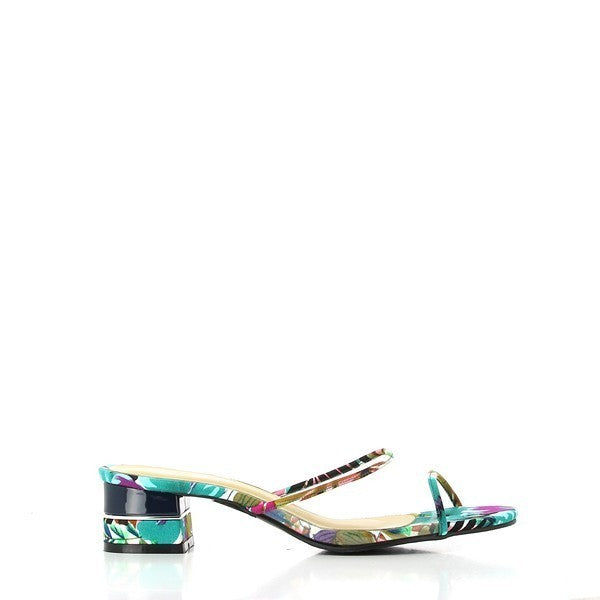The Dalessi Dejavu Blue Slides are displayed against a light, neutral background. The slides feature two thin, leather straps adorned with delicate tropical motifs in shades of blue, giving them an airy, summery vibe. The 5 cm platform heel subtly elevates the shoe, showcasing the synthetic sole designed for durability and grip. The round toe shape enhances comfort, while the soft leather upper and lining add a touch of luxury. 
