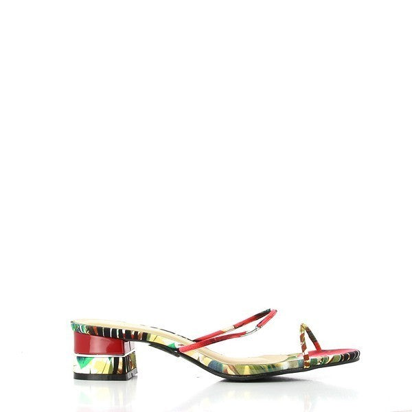 The Dalessi Dejavu Red Floral Slides are displayed from a side angle, showcasing their vibrant red color and delicate floral tropical motifs on the two thin straps. The smooth leather upper complements the soft leather lining, visible from the open sides of the shoe. The 5 cm platform heel provides a subtle lift, while the round toe design ensures comfort and a relaxed fit. The durable synthetic sole is visible at the bottom, emphasizing the practical yet stylish nature of these slides. 