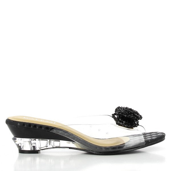 A side view of the Dalessi Dualism Black Slide, highlighting the sleek transparent upper and round toe shape, complemented by the subtle 2.5 cm heel-platform for a comfortable lift.