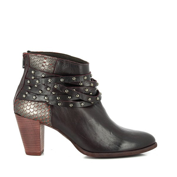 The side view showcases the sleek silhouette of the burgundy leather ankle boots, with the striking snake print pattern and decorative upper straps with studs. The back zipper is subtly visible, complementing the boot's elegant design.