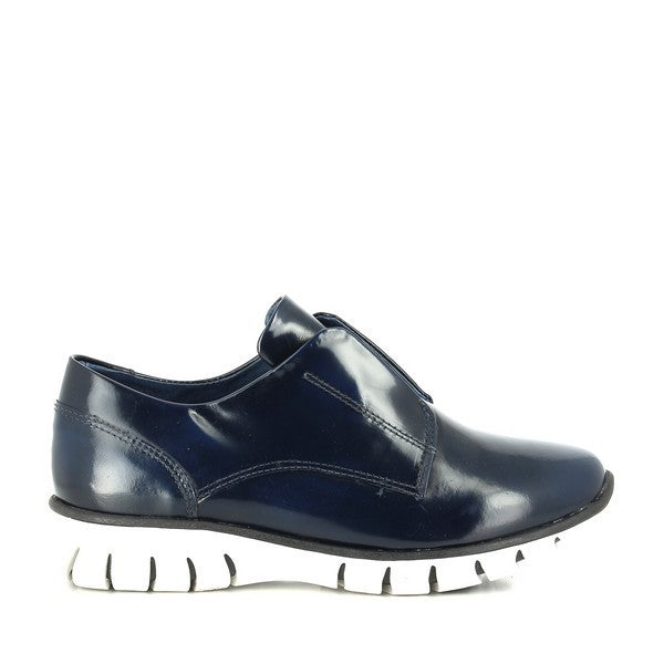 A close-up shot of the Felmini 9880 navy slip-on shoe from the side, showcasing its sleek and minimalist design. The smooth leather upper and round toe provide a sophisticated, modern look.