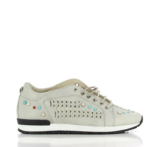 A sleek side view of the Felmini A218 Grey Sneakers showcases the smooth leather upper adorned with sparkling decorative jewel studs, complemented by a subtle 1cm platform sole and a rounded toe design.

