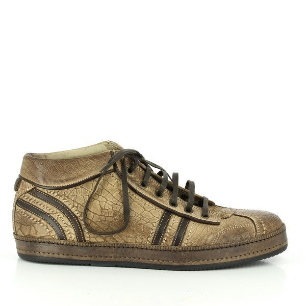 A sleek side profile showcasing the golden leather upper with smooth, hand-buffered detailing. Brown accents highlight the laces and side line, adding a touch of contrast. The flat synthetic sole extends seamlessly, ensuring a refined yet casual appearance.
