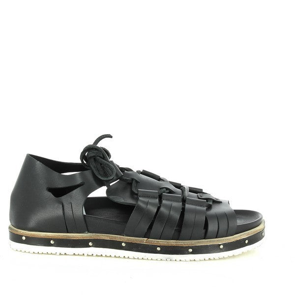 A side profile of the sandal showcasing its sleek black leather upper, intricate Roman-style strap design, and the slight elevation of the 2.5cm heel. The synthetic sole adds a contemporary touch, ensuring both style and durability.