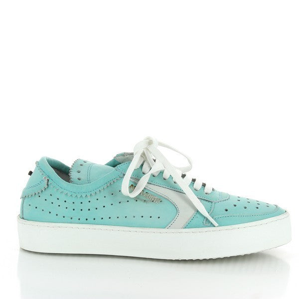 A sleek profile of the sneaker showcasing the mint green leather upper, a clean white line running along the sole, and perforated accents for added style.