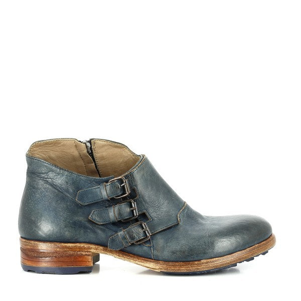 A full view of the Forte W155140 Blue Ankle Boots showing the sleek silhouette, with three decorative straps across the outer side, accentuating the bold design. The smooth leather upper, finished in a deep blue hue, catches the light.