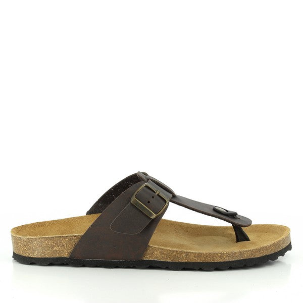 An image showcasing Plakton's 100012 Dark Brown Thong Sandals, laid against a backdrop of sandy beach. The sandals exude casual elegance with their classic thong style and dark brown leather straps. Crafted in Spain, they promise comfort and durability for every summer adventure.