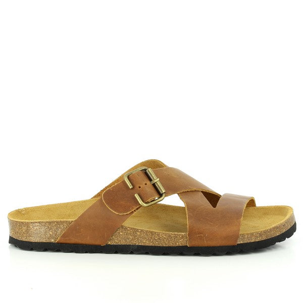 In this captivating photo, the 105053 Brown Cross-Strap Sandals take center stage. Crafted from sumptuous Tango leather, the intricate details of the individually adjustable straps and rounded toe shape are highlighted. Beneath, the natural cork footbed promises unparalleled comfort and a connection to the earth, while the durable EVA sole ensures stability on any terrain. Immerse yourself in the perfect blend of style and comfort with Plakton's handmade sandals.